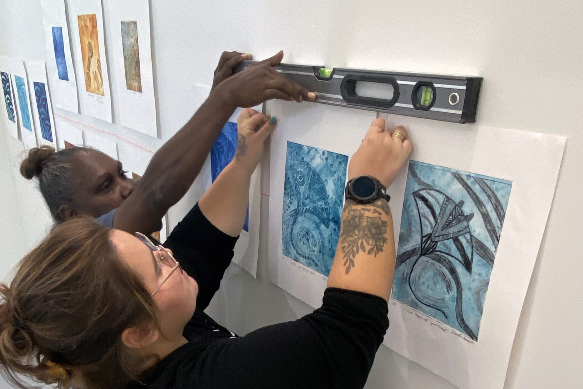 Monica Henry and Rekeshia Goodwin installing artwork for their exhibition at North Metropolitan TAFE studio, March 2024.