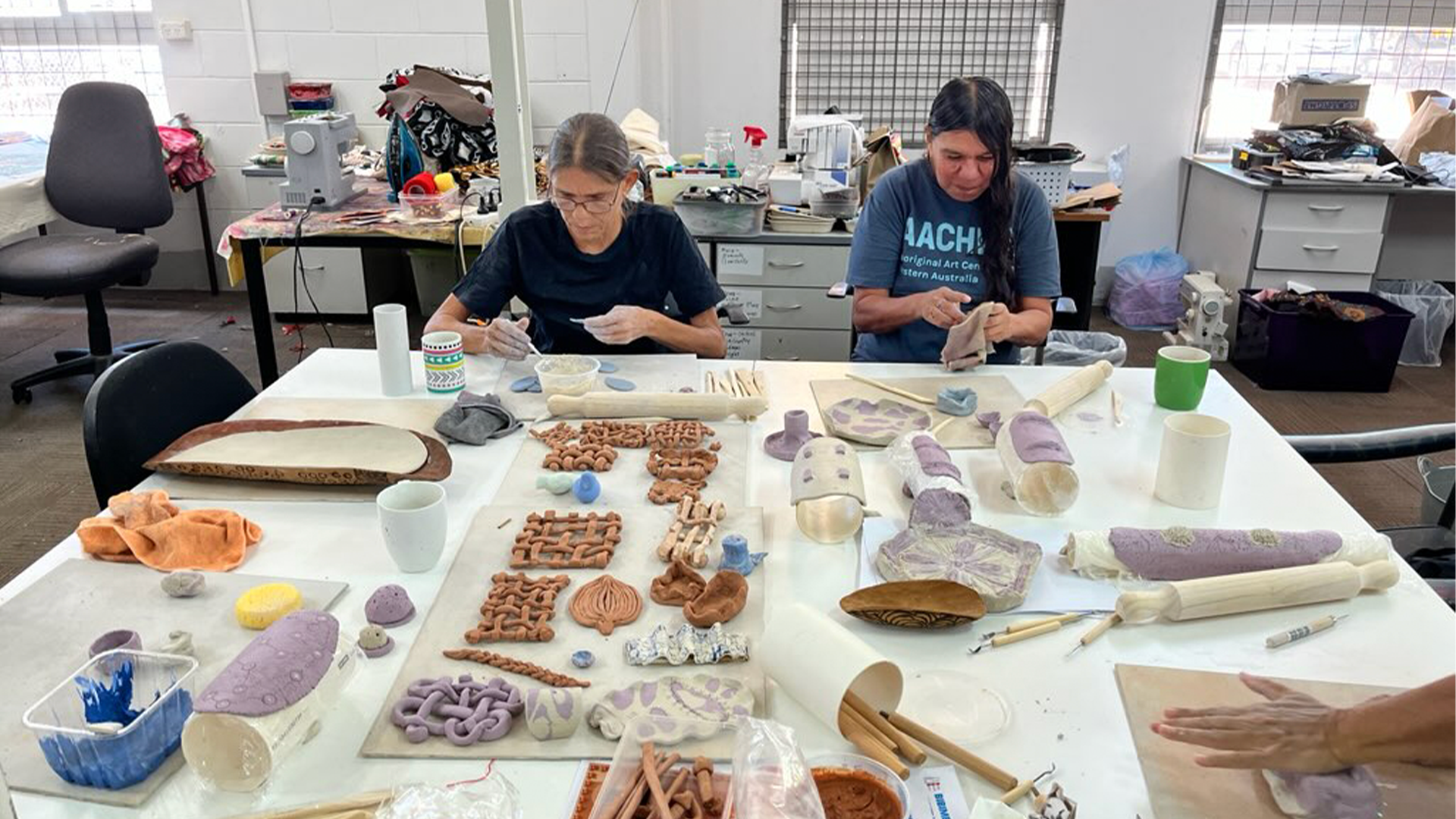 Kathleen Holzhauser & Lorraine Hunter creating their ceramic masterpieces in the Nagula Jarndu Designs studio, during the ceramics workshop facilitated by North Regional TAFE Lecturer and artists Tanya Lee.  
Our Country Moves, Rubbi (Broome) November 2024, 