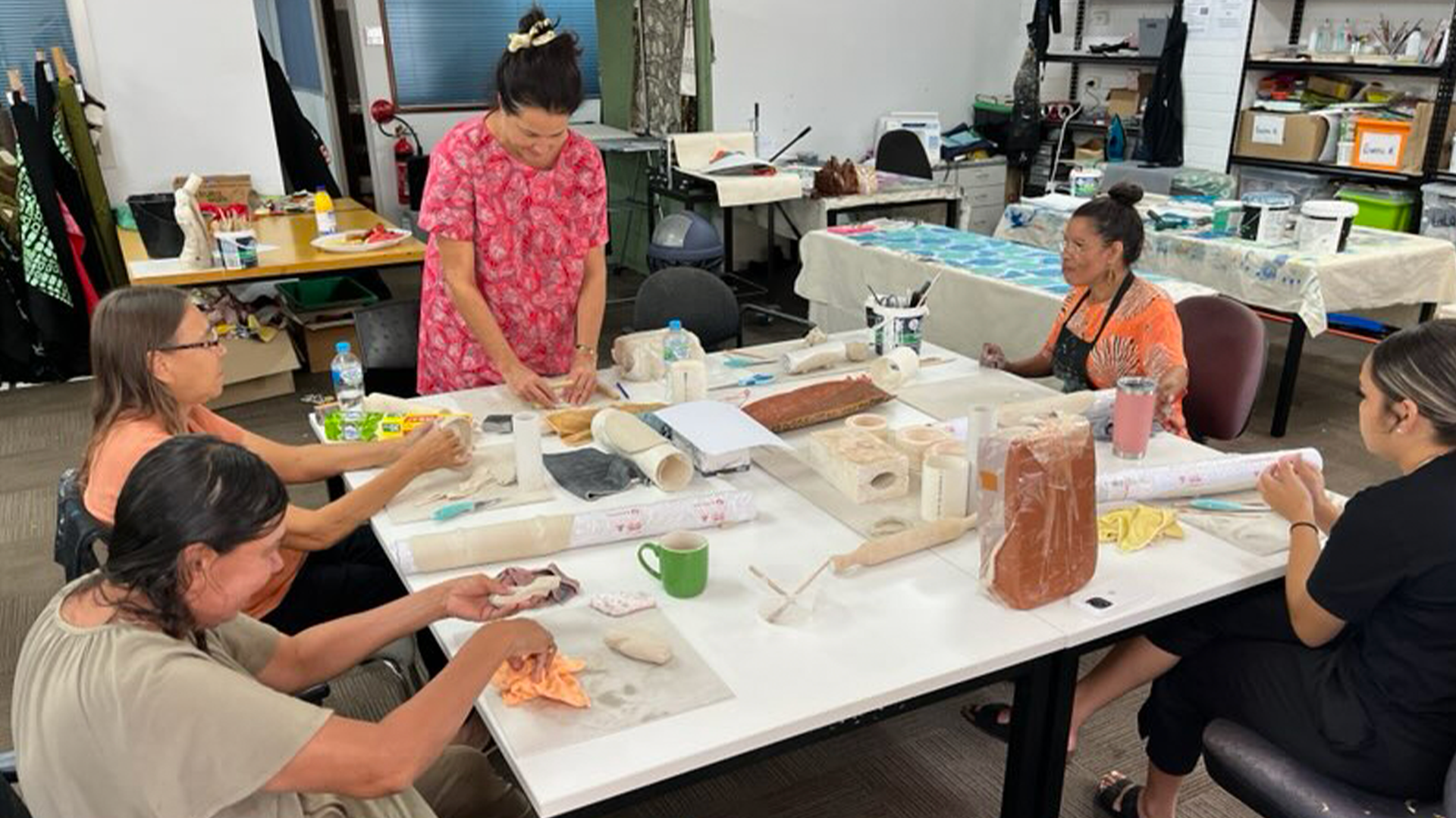 Nagula Jarndu Designs artists creating their ceramic masterpieces in the studio, during the ceramics workshop facilitated by North Regional TAFE Lecturer and artists Tanya Lee.  
Our Country Moves, Rubbi (Broome) November 2024, Photography by Tanya Lee.